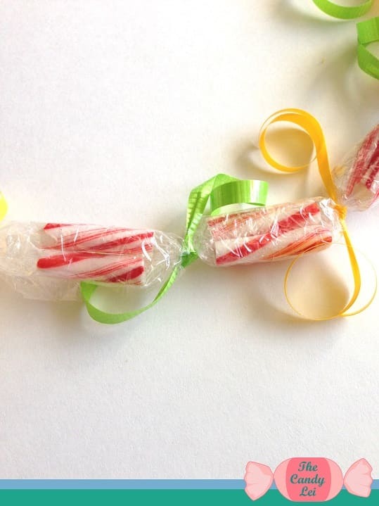 Curl the ribbon on your candy cane lei