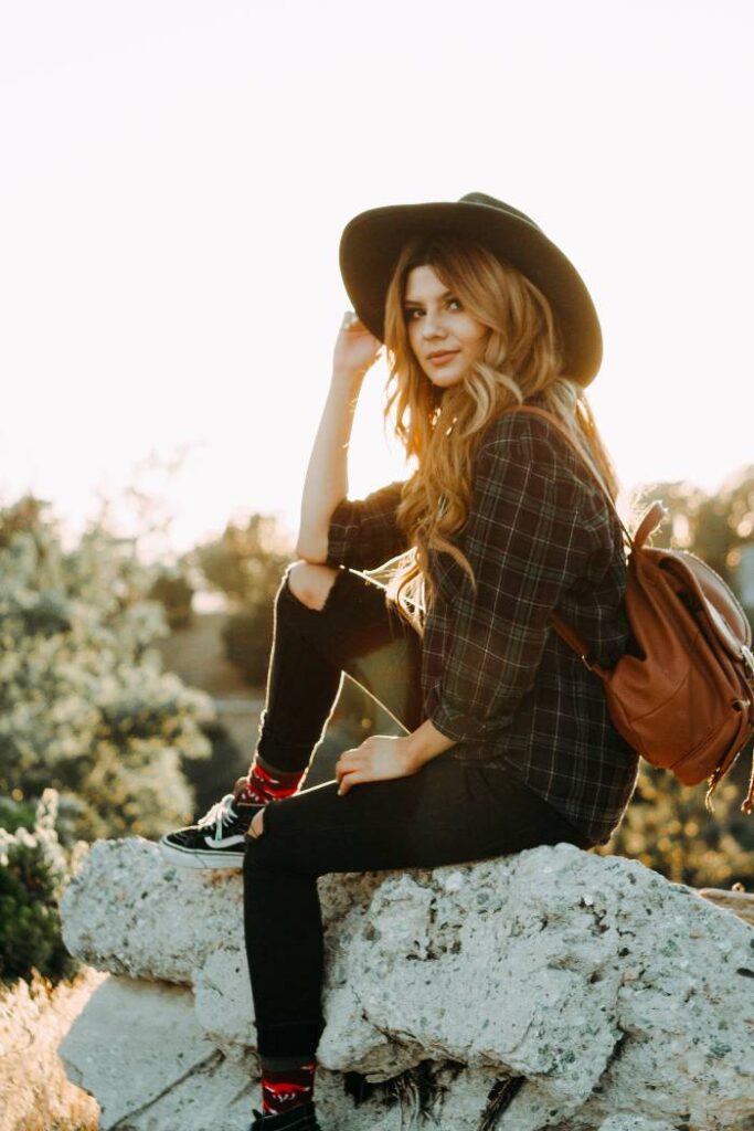 spring senior portrait sitting on a rock