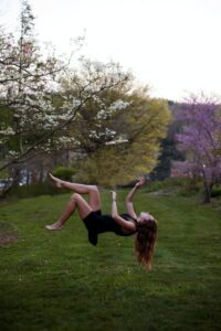 women jumping for senior picture