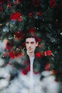 man with red flowers