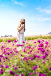 women in dress in flower field